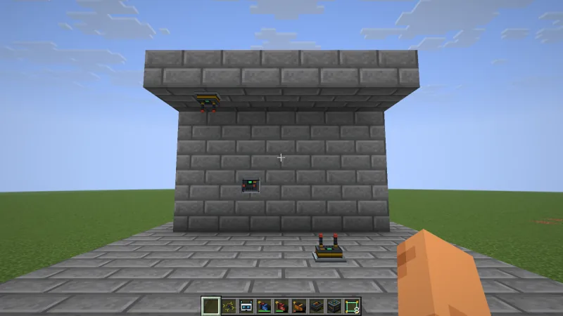 Three small signal repeaters with two antennas and a green status light: one on the floor, one on a stone brick wall and one hanging from the ceiling of an overhang
