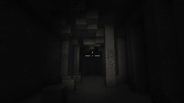 FPV view down a dark cave tunnel with the LED headlight on: the stone pillars ahead are lit